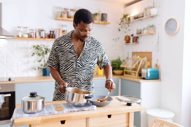 istock Black man serving food for lunch 2163215820