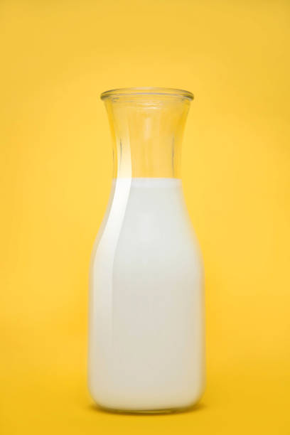 istock Milk bottle isolated on yellow background. Vertical photography. 2163216922