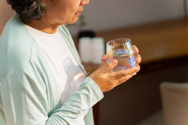 istock Asian elderly woman drinking water. 2163218495