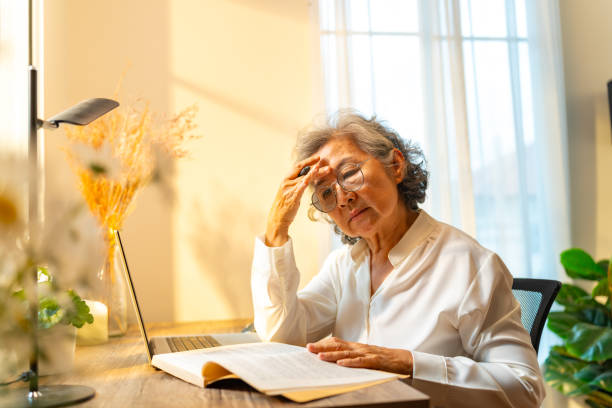 istock Asian elderly woman working on laptop computer at home. 2163218711