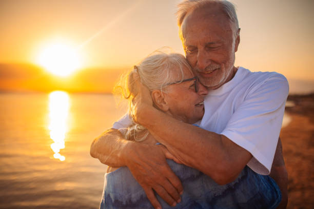 istock Elderly couple sharing an emotional hug at sunset 2163219716
