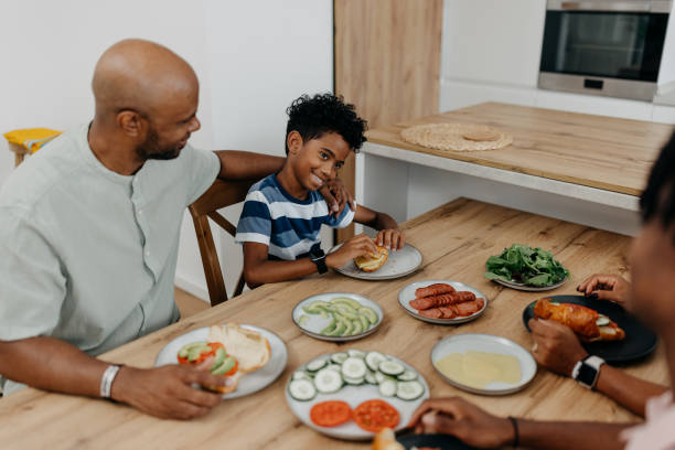 istock Father and son smiling while having lunch together 2163219915