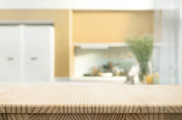 istock Selective focus.End grain wood counter top with  blur kitchen in morning light window background. 2163220433