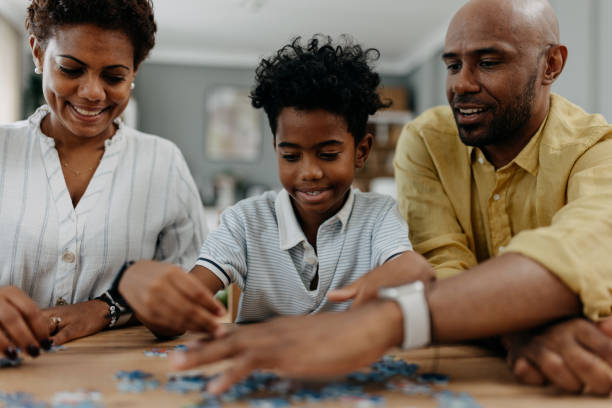istock Parents and kids enjoying a puzzle at the table. 2163220957