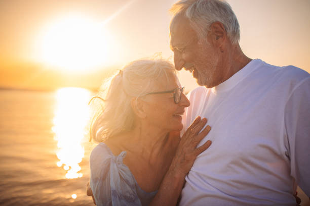istock Elderly couple's serene moment by the sunset sea 2163221427