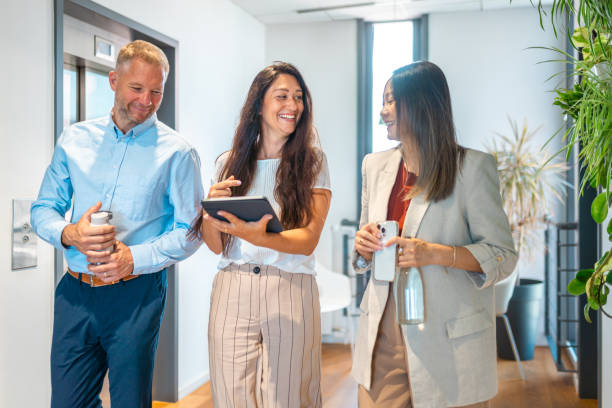 istock Diverse Team Engages in Office Corridor Meeting with Tablet 2163222205