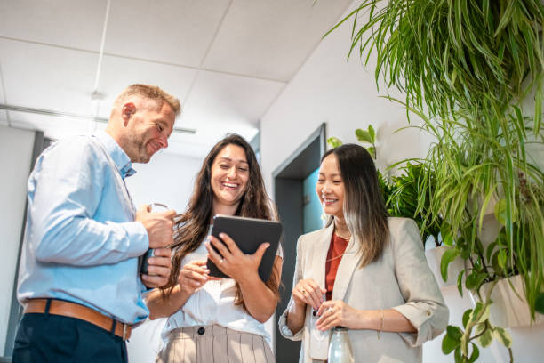 istock Diverse Team Engages in Office Hallway Meeting 2163222318