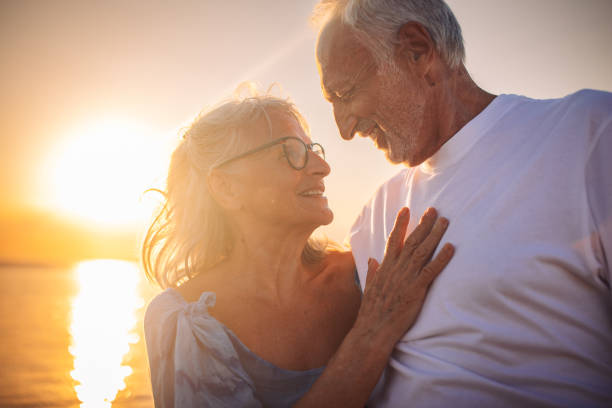 istock Embracing elderly couple by the waterfront at sunset 2163222464