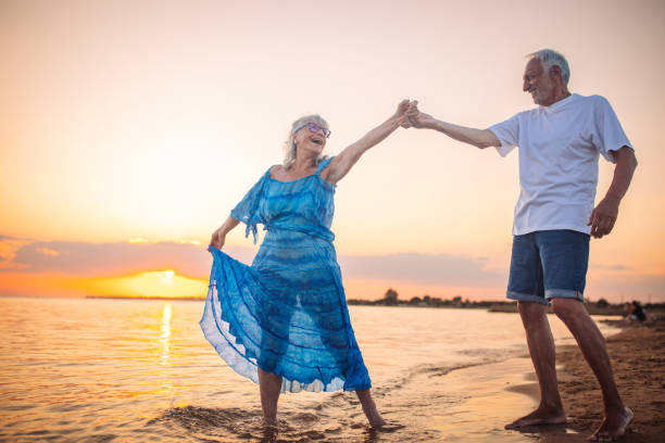 istock Joyful dance by elderly duo in calming beach sunset 2163223407