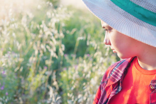 child in the field observing the vegetation