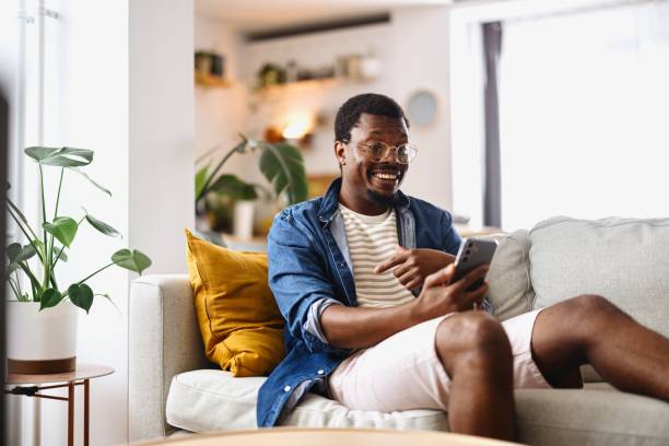 istock Modern man talking with someone on a video call at home 2163225479