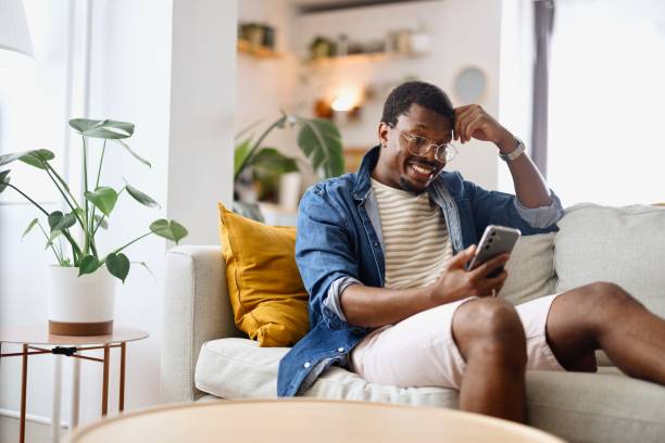 istock Man having a video call with his friends at home 2163225481