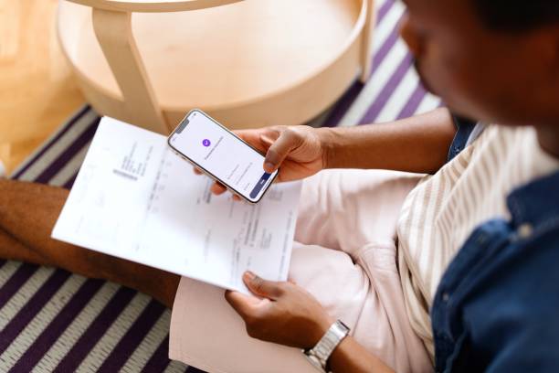 istock Man using online banking on his smartphone 2163225660