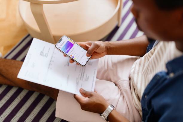 istock Close-up of a man using online banking on his smartphone 2163225665
