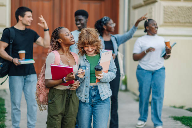 istock Diverse female students walking towards camera and exiting university. 2163225991