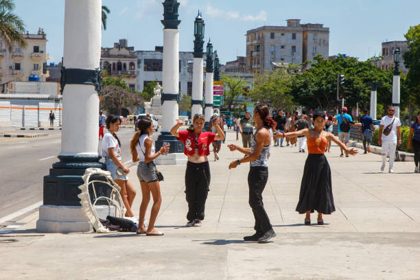 Havana, Cuba - May 29, 2024: A group of young Cuban artists dancing on a city sidewalk in the downtown district.