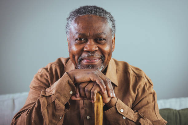 istock Elderly Black Man with Walking Stick in Home Setting 2163227258