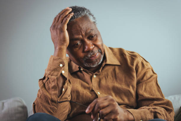 istock Elderly Black Man Experiencing Discomfort on Couch 2163227264