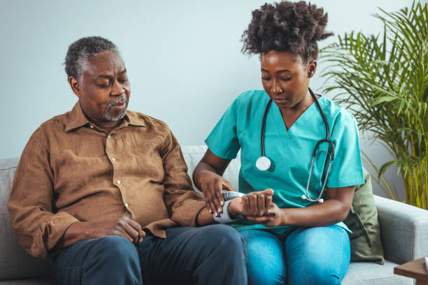 istock Caring Nurse Checking Elderly Patient's Blood Pressure at Home 2163227288