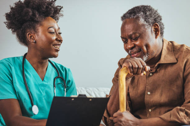 istock Caring Nurse Providing In-Home Assistance to Senior Man 2163227306