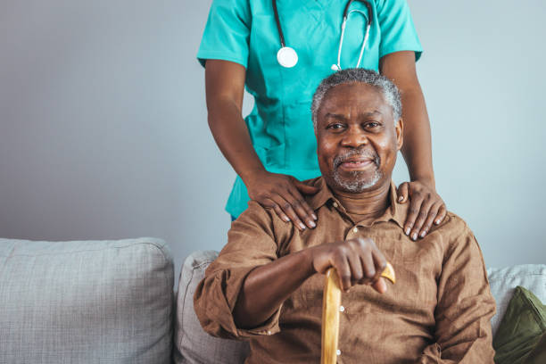 istock Caring Nurse Attends to Senior Man at Home 2163227314