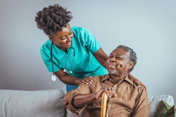 istock Caring Nurse Assists Elderly Gentleman at Home 2163227329