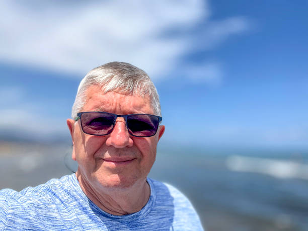 istock Senior Caucasian man selfie outdoors at beach 2163227460