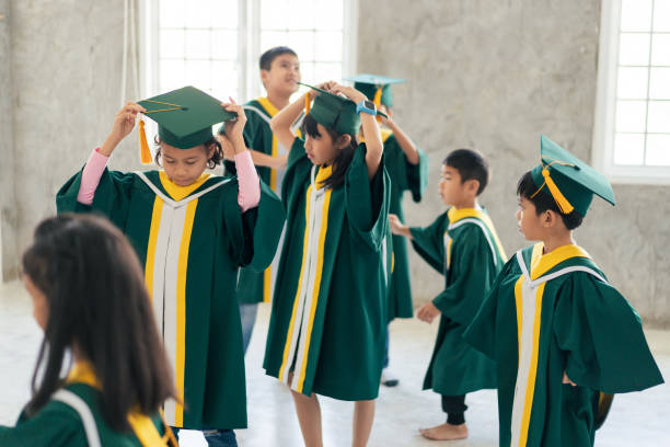 istock Childhood students and friends with graduation 2163227480