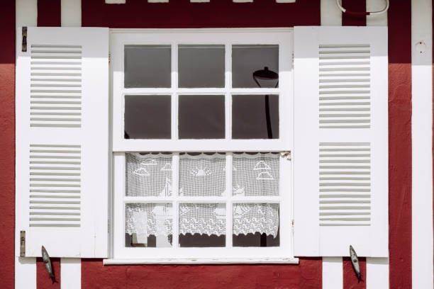 Small wooden window on white wall.