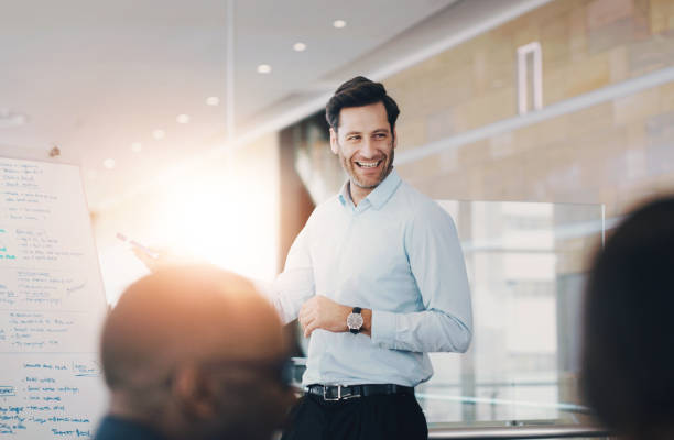 istock Whiteboard, presentation and happy business man in meeting for coaching, training or discussion. Team, leader and public relations manager planning strategy for social media campaign info in workshop 2163229192