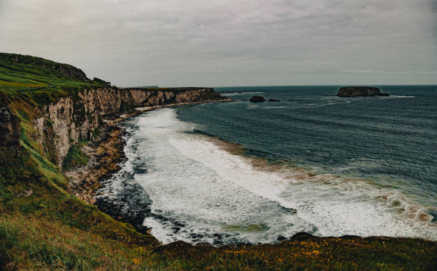 A Rugged Bay near Carrick-a-Rede rope bridge in Ballintoy, Antrim, Ballycastle, Northern Ireland - long exposure