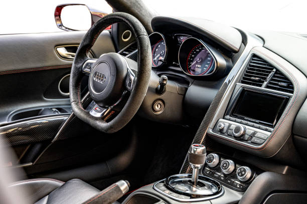 Audi R8 sports car dashboard. The Audi R8 is a mid-engine, two-seater sports car manufactured and marketed by the German automobile manufacturer Audi. The Audi R8 V10 Plus is a high-performance variant of the Audi R8 sports car.