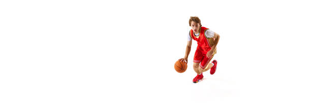 Banner. Young man, basketball athlete training dribbling technique against white studio background with negative space to insert text. Concept of professional sport, competition, match, team games. Ad