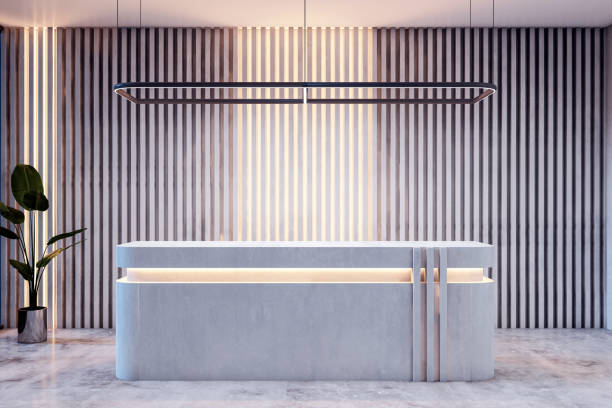 istock A modern office lobby with an empty reception desk, concrete and wood features, clean design, illuminated by soft light, concept of a business entrance. 3D Rendering 2163240123