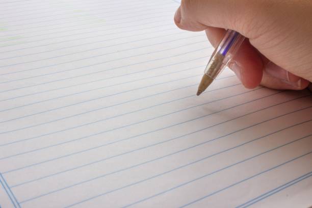 Closed picture of a person writing on a blank page