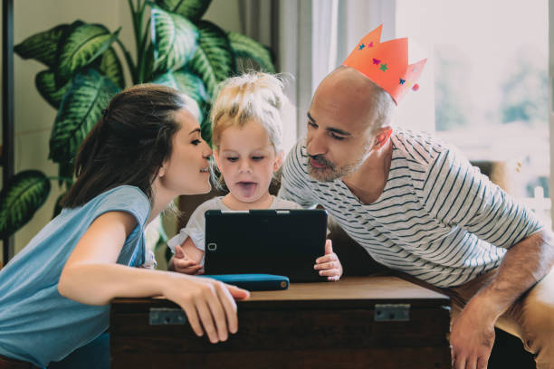 istock Happy family using digital tablet at home 2163243114