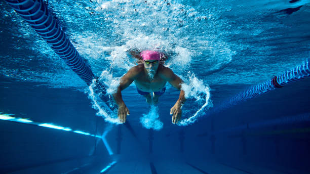 istock Competitive swimmer, man with athletic physique captured underwater during intense training session under water in clean pool. 2163243983