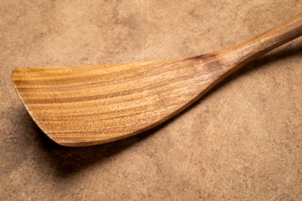 istock spatula - wooden kitchen cooking utensils on textured bark paper 2163244576