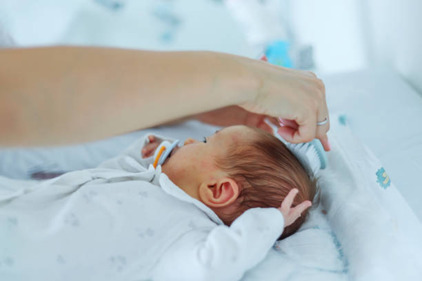 istock mother combing the baby's hair with bristle brush 2163246165