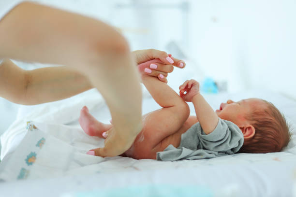 istock A mother changes her child's diaper, close-up 2163246225