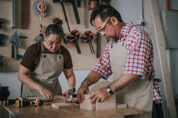 istock Asian senior carpenter working with daughter in woodshop workshop 2163251921
