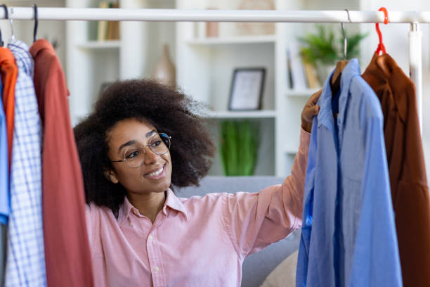 istock Smiling woman choosing clothes from wardrobe in modern home interior 2163251992