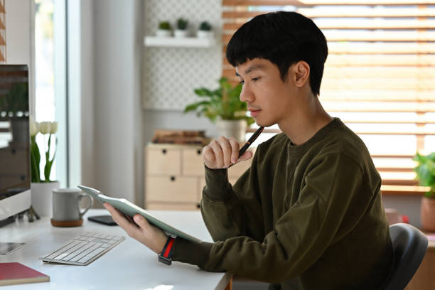 istock Side view with Thinking Businessman working on office desk at home office. 2163252770