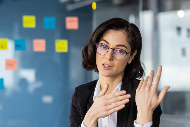 istock Businesswoman explaining ideas during a video call in an office setting 2163253680