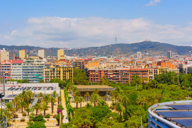 Vibrant urban landscape showcasing lush greenery intertwined with modern buildings, offering a picturesque view of Barcelona’s unique architecture against a mountain backdrop.