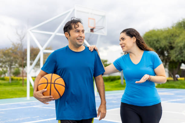 istock Hispanic couples happy and healthy practicing basketball 2163262289