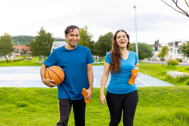 istock Hispanic couples happy and healthy practicing basketball 2163262460