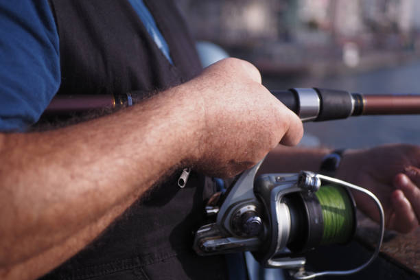 Fisherman with rod, spinning reel