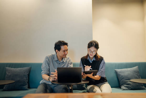 istock business persons working in a modern green office 2163263826