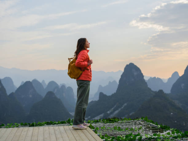 istock Woman standing in viewpoint overlooking Li River in Guilin 2163268131
